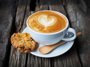 A cup of espresso with an oatmeal cookie