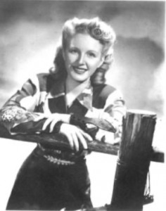 Image of Carolina Cotton, western performer and yodeler, standing at a fence