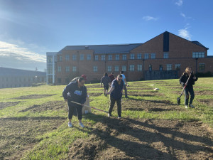 A group of faculty and students planting on Indigenous Peoples Day A group of faculty and students planting and tilling in seeds on Indigenous Peoples Day