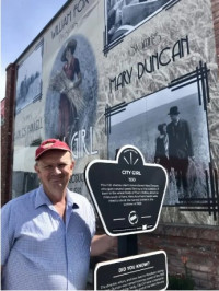 Rob McIntyre outside the Gem Theatre's "City Girl" mural Rob McIntyre outside the Gem Theatre's "City Girl" mural
