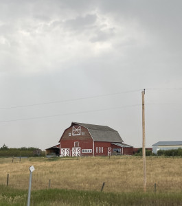 Image of a historic barn near a wheat field